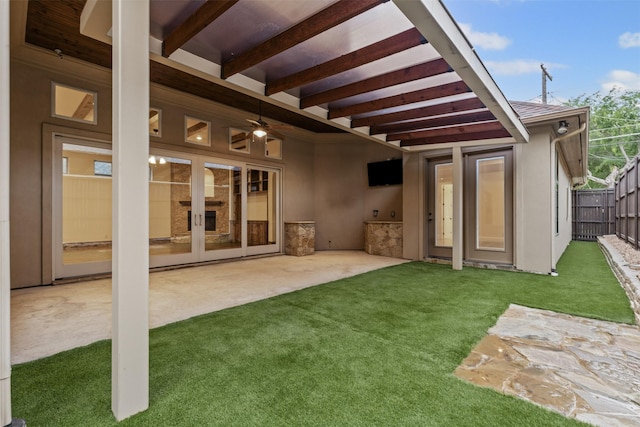 back of property featuring a patio, stucco siding, french doors, and a ceiling fan