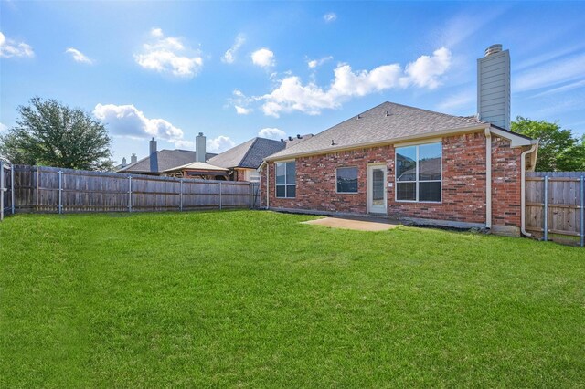 2691 Waterdance Dr, Little Elm, TX 75068 - rear view of property featuring a chimney, brick siding, a shingled roof, and a patio area