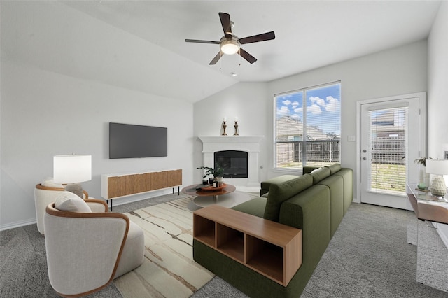 2691 Waterdance Dr, Little Elm, TX 75068 - carpeted living area featuring a ceiling fan, a glass covered fireplace, baseboards, and lofted ceiling