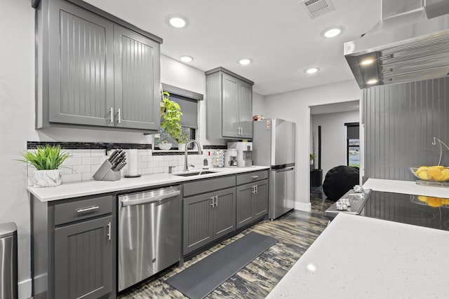2512 Bennett Ave, Sherman, TX 75090 - kitchen featuring appliances with stainless steel finishes, gray cabinetry, a sink, exhaust hood, and recessed lighting