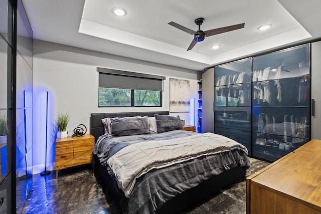 2512 Bennett Ave, Sherman, TX 75090 - bedroom featuring a tray ceiling, concrete floors, recessed lighting, and a ceiling fan
