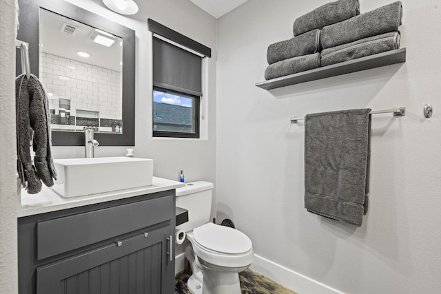 2512 Bennett Ave, Sherman, TX 75090 - bathroom with vanity, toilet, and baseboards