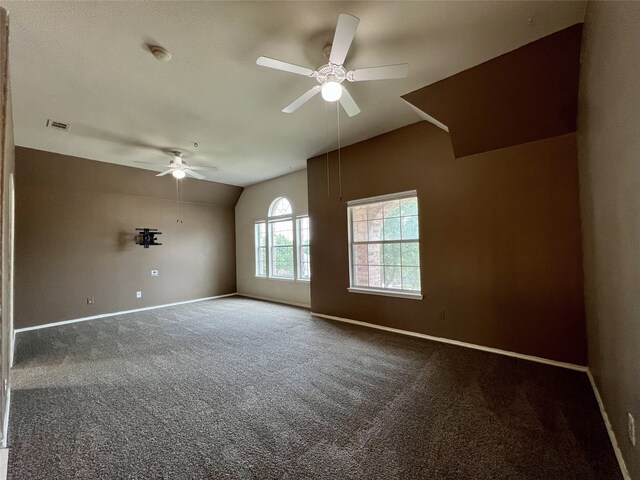 unfurnished room featuring lofted ceiling, ceiling fan, baseboards, carpet flooring, and a smoke detector