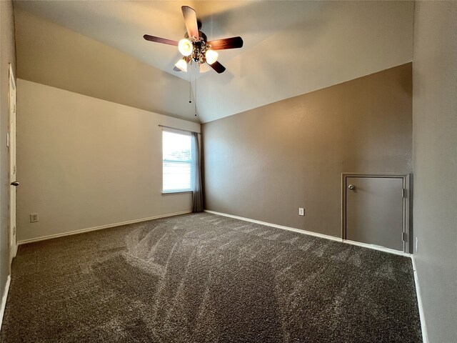 spare room featuring a ceiling fan, lofted ceiling, carpet, and baseboards