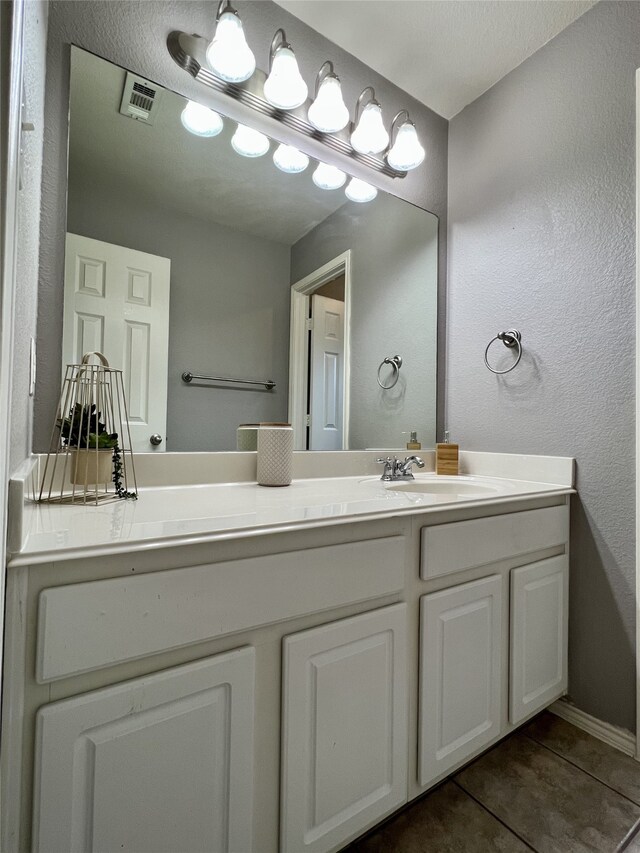 bathroom featuring vanity, tile patterned floors, and baseboards