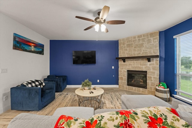 2643 Perdenales Dr, Royse City, TX 75189 - living area featuring ceiling fan, wood finished floors, baseboards, a fireplace, and an accent wall