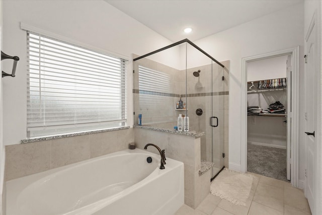 2643 Perdenales Dr, Royse City, TX 75189 - bathroom with a shower stall, a garden tub, a walk in closet, and plenty of natural light