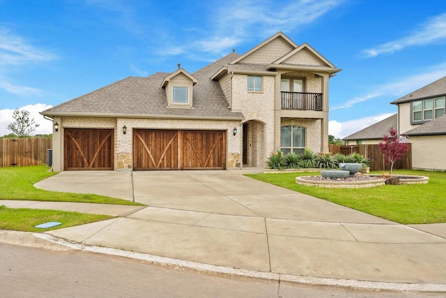 2643 Perdenales Dr, Royse City, TX 75189 - view of front facade with a balcony, a garage, concrete driveway, a shingled roof, and brick siding