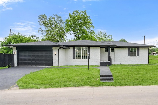 view of front of house with driveway, an attached garage, and brick siding
