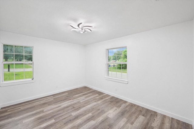 unfurnished room featuring wood finished floors and baseboards