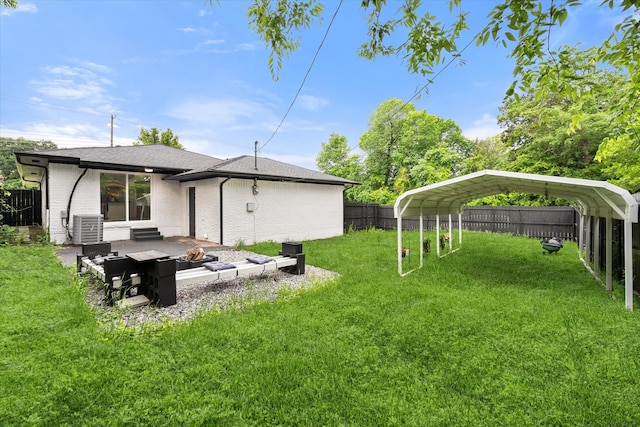 view of yard with central air condition unit, a detached carport, and a fire pit