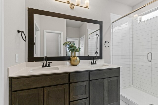 bathroom with a stall shower and double vanity