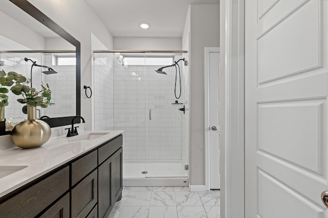 bathroom with a stall shower, marble look tiles, and double vanity