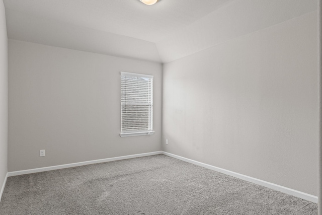 carpeted spare room with baseboards