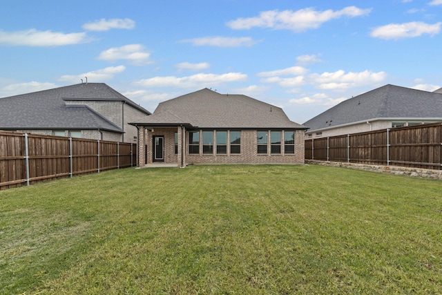 rear view of house with brick siding and roof with shingles