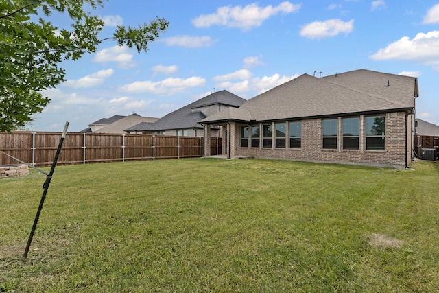 rear view of house with brick siding and roof with shingles
