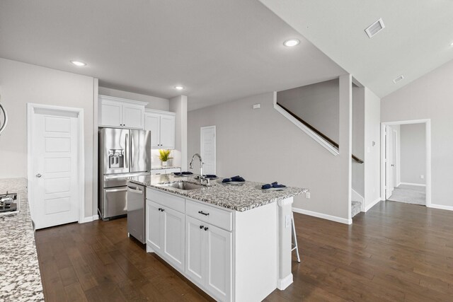 kitchen featuring a sink, appliances with stainless steel finishes, dark wood-style floors, recessed lighting, and white cabinets