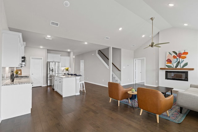 living room featuring stairs, dark wood-style floors, recessed lighting, ceiling fan, and lofted ceiling