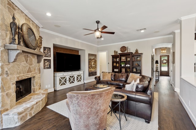 850 Long Valley Ct, Prosper, TX 75078 - living room with ceiling fan, arched walkways, wood finished floors, a stone fireplace, and ornamental molding