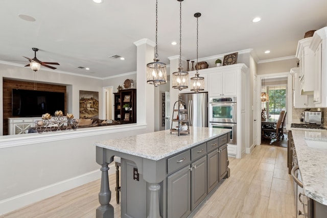 850 Long Valley Ct, Prosper, TX 75078 - kitchen with gray cabinetry, appliances with stainless steel finishes, a chandelier, white cabinetry, and ornamental molding