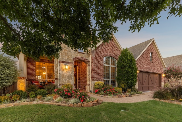 850 Long Valley Ct, Prosper, TX 75078 - english style home with brick siding, a front yard, a garage, and a shingled roof