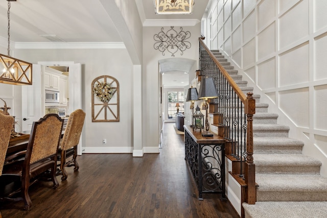 850 Long Valley Ct, Prosper, TX 75078 - entrance foyer featuring baseboards, ornamental molding, dark wood finished floors, stairs, and arched walkways