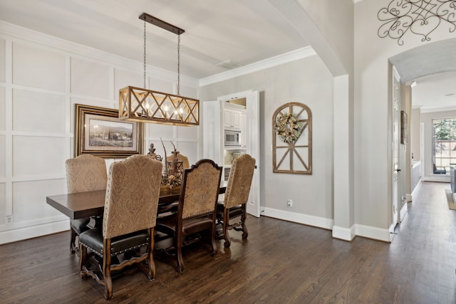 850 Long Valley Ct, Prosper, TX 75078 - dining area with arched walkways, crown molding, dark wood-style flooring, and baseboards