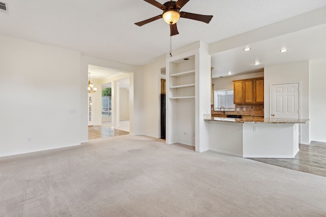 10008 Preston Vineyard Dr, Frisco, TX 75035 - unfurnished living room with a chandelier, a ceiling fan, plenty of natural light, light carpet, and recessed lighting
