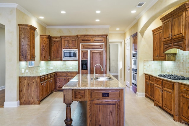 1727 Lantana Ln, Frisco, TX 75033 - kitchen featuring a sink, built in appliances, a kitchen island with sink, light stone countertops, and backsplash