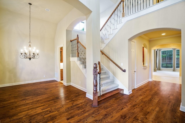 1727 Lantana Ln, Frisco, TX 75033 - stairway with wood finished floors, a high ceiling, baseboards, a chandelier, and crown molding