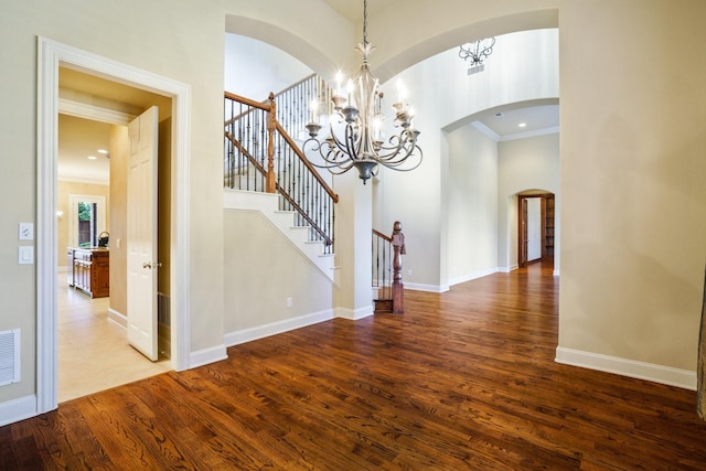 1727 Lantana Ln, Frisco, TX 75033 - interior space featuring a chandelier, wood finished floors, baseboards, stairway, and arched walkways