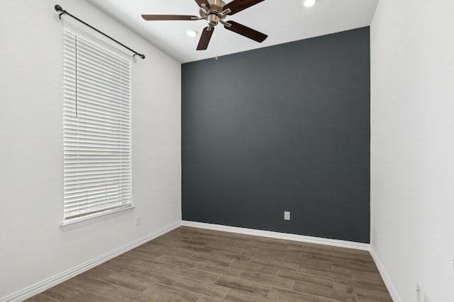 empty room featuring a ceiling fan, recessed lighting, wood finished floors, and baseboards