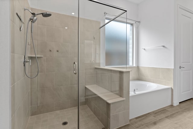 full bath featuring a shower stall and a bath