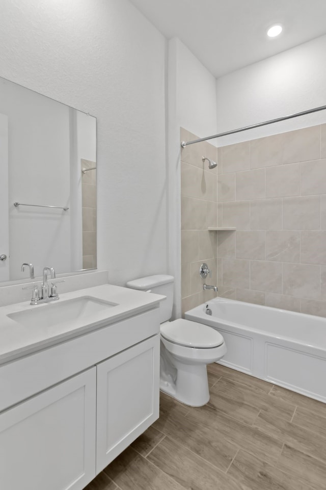 full bath featuring toilet, vanity, shower / bathtub combination, and wood finished floors