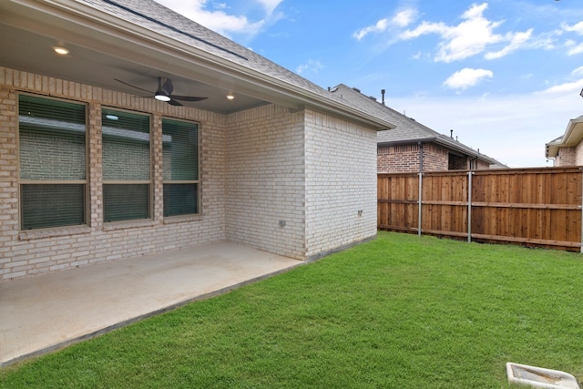 view of yard with a ceiling fan and a patio