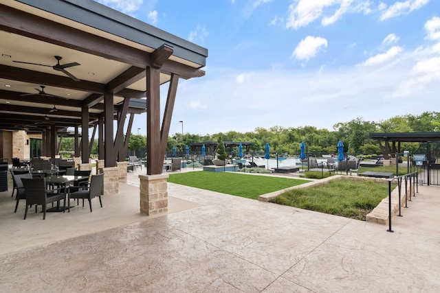 view of patio / terrace featuring a pool, a ceiling fan, and outdoor dining area