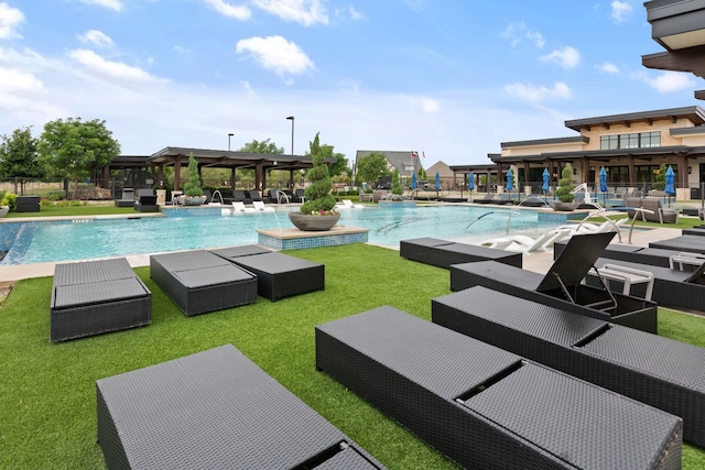community pool with a patio and a lawn