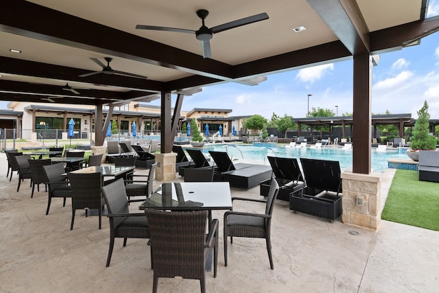 view of patio with a ceiling fan and a community pool