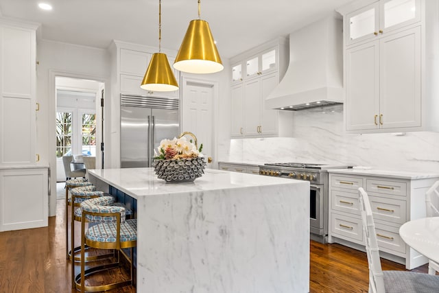 3428 Stanford Ave, University Park, TX 75225 - kitchen with premium appliances, custom range hood, a breakfast bar area, a center island, and backsplash
