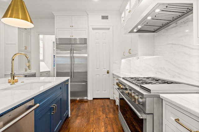 3428 Stanford Ave, University Park, TX 75225 - kitchen with high end appliances, a sink, blue cabinets, custom range hood, and white cabinets