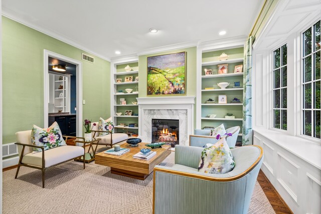 3428 Stanford Ave, University Park, TX 75225 - living area with wood finished floors, a high end fireplace, crown molding, healthy amount of natural light, and built in shelves