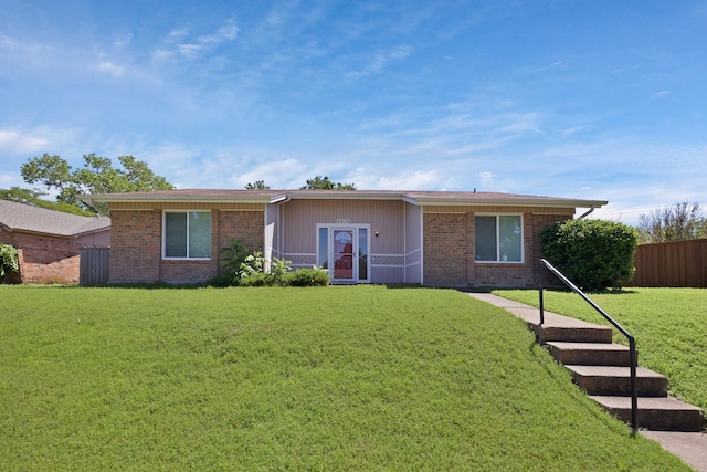 ranch-style house featuring brick siding