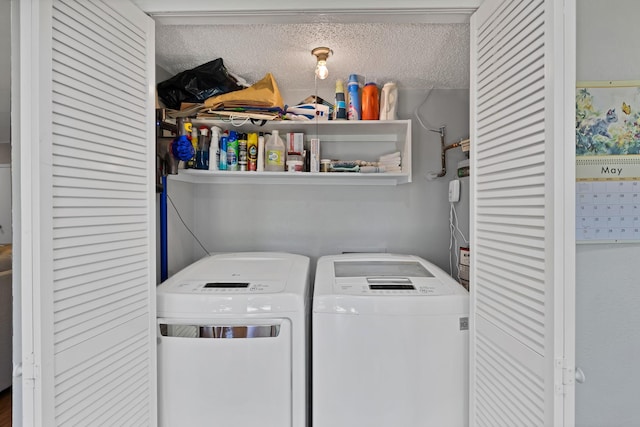washroom featuring independent washer and dryer and a textured ceiling