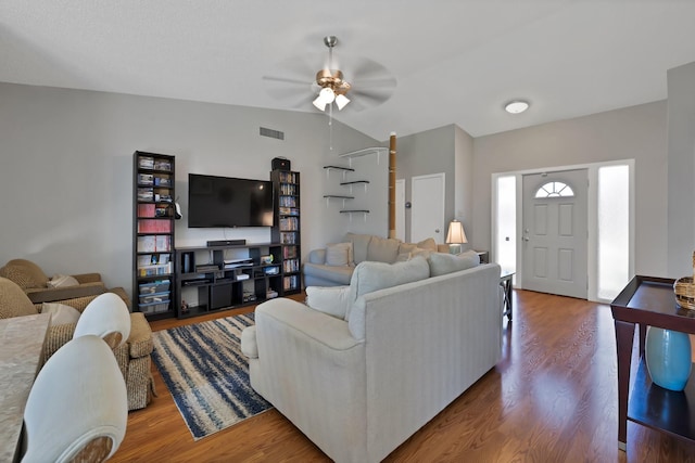 living room with vaulted ceiling, a ceiling fan, and wood finished floors