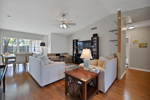 living room with vaulted ceiling, a ceiling fan, dark wood finished floors, and baseboards