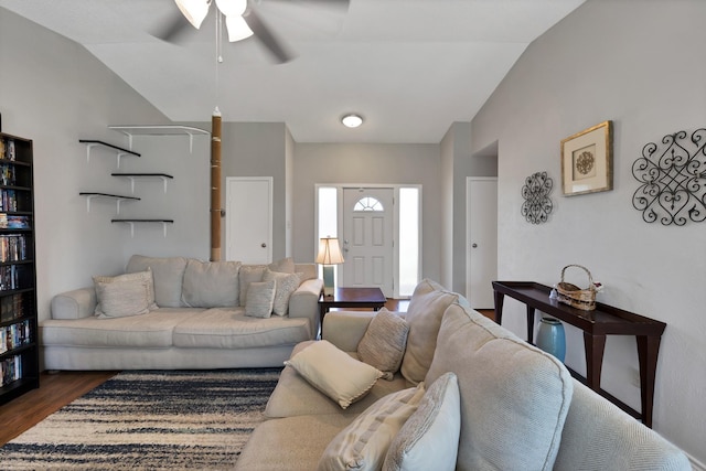 living room featuring ceiling fan, vaulted ceiling, and dark wood-type flooring