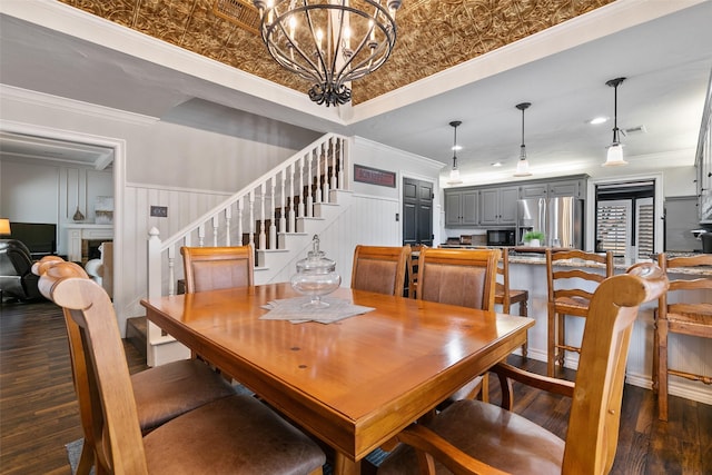6701 Timothy Dr, Plano, TX 75023 - dining room with stairway, dark wood finished floors, ornamental molding, a chandelier, and a wainscoted wall