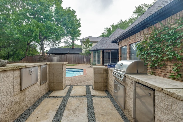 6701 Timothy Dr, Plano, TX 75023 - view of patio featuring exterior kitchen, grilling area, a fenced backyard, and a sunroom