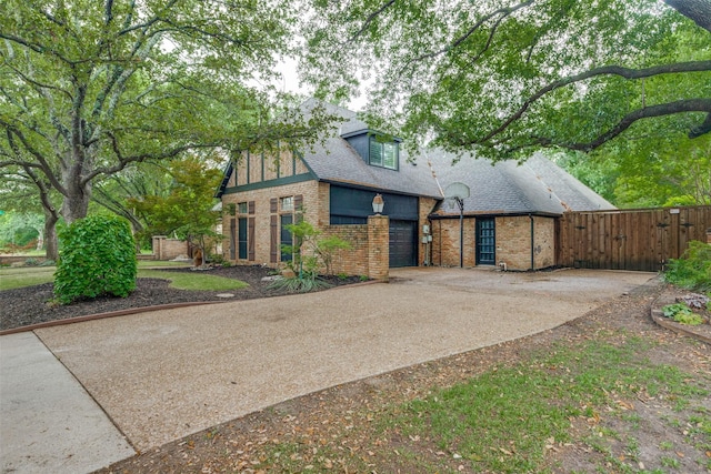 6701 Timothy Dr, Plano, TX 75023 - view of front facade featuring brick siding, driveway, a gate, fence, and a shingled roof