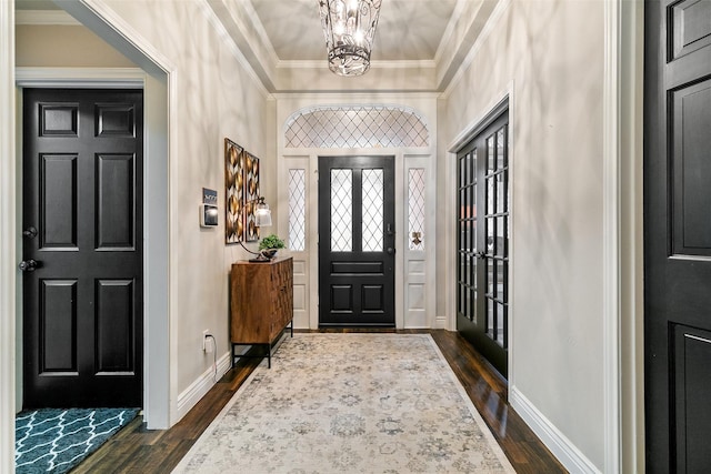6701 Timothy Dr, Plano, TX 75023 - entrance foyer with a chandelier, dark wood finished floors, crown molding, and baseboards